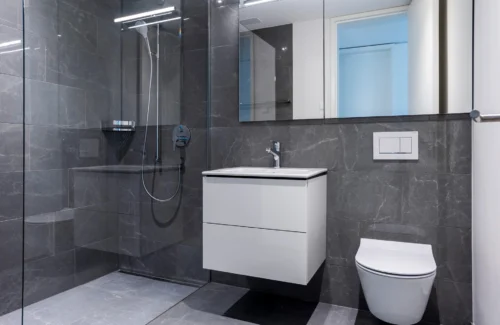 Modernes Badezimmer mit Glasduschkabine und weißer Einrichtung